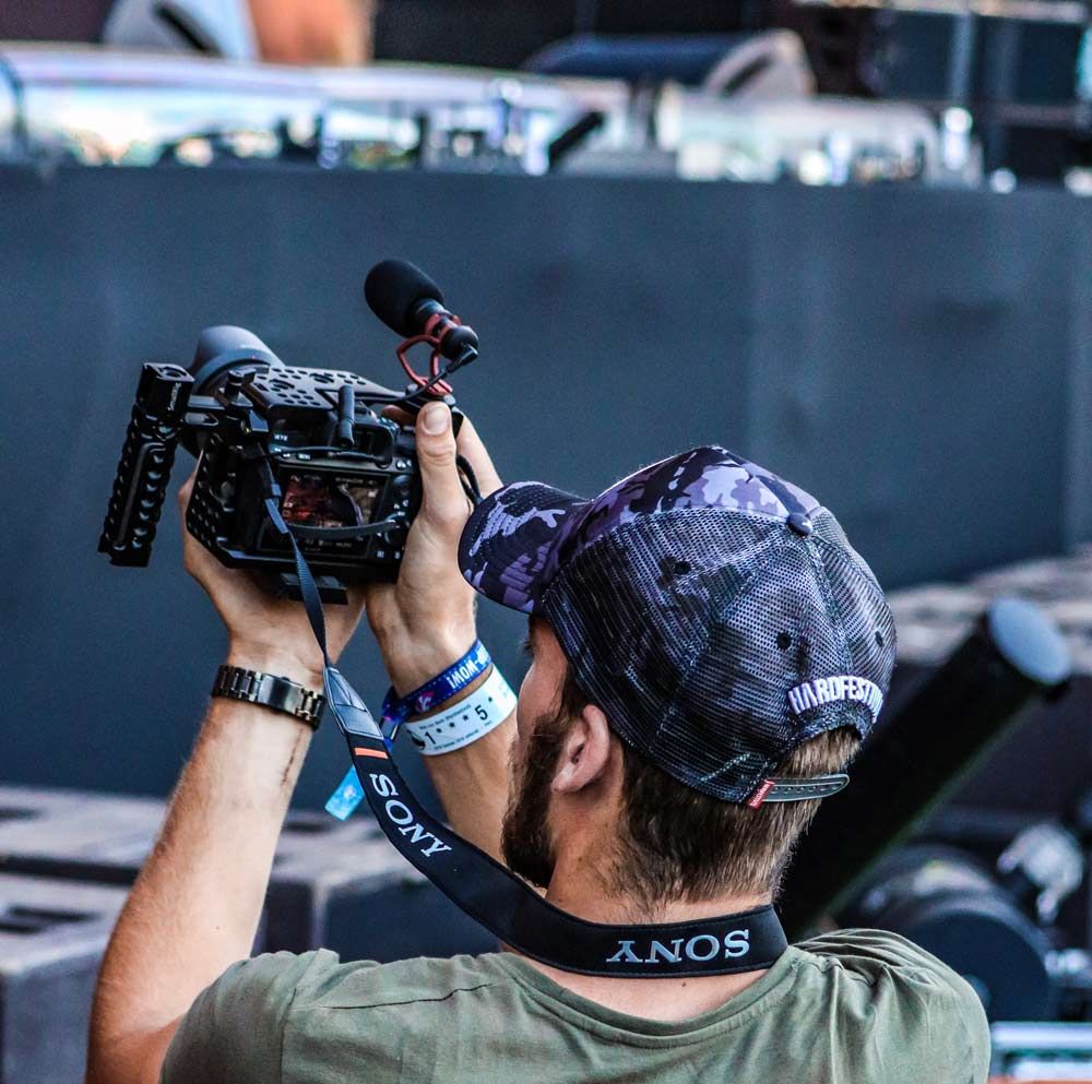 Niek filmt van dichtbij met een camera boven zijn hoofd